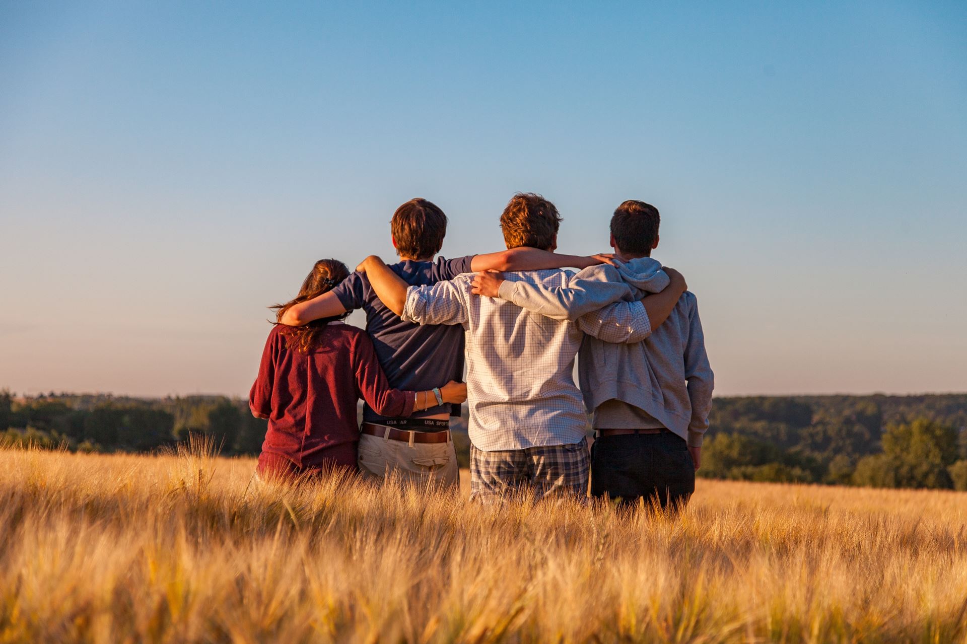 people with arms around each other 